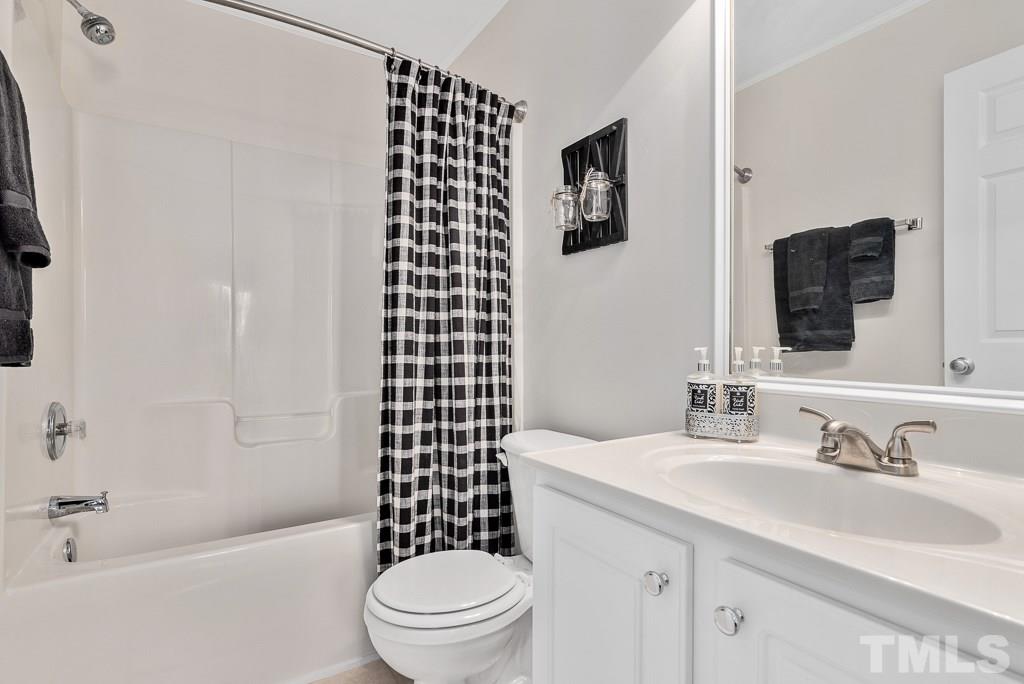 8348 City Loft Court Raleigh, NC 27613 - Photo 17 of 24 a bathroom with a sink a toilet and shower