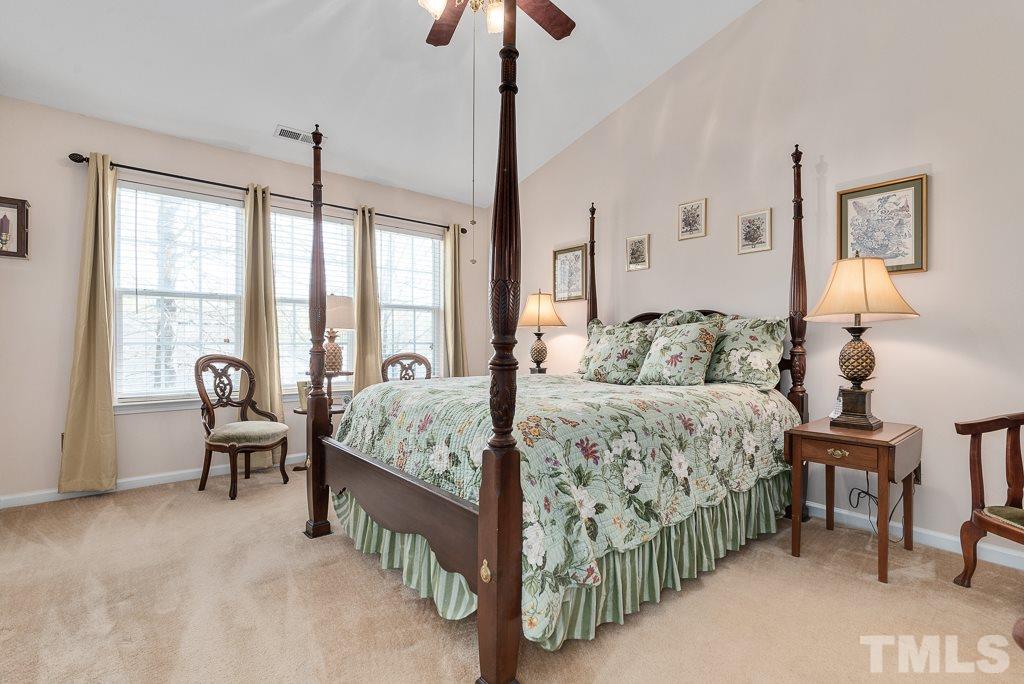 8348 City Loft Court Raleigh, NC 27613 - Photo 18 of 24 a bedroom with a bed chandelier and a window