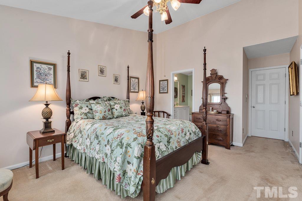 8348 City Loft Court Raleigh, NC 27613 - Photo 19 of 24 a bedroom with bed and a chandelier