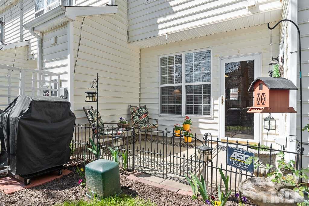 8348 City Loft Court Raleigh, NC 27613 - Photo 23 of 24 a view of a porch with chairs and a potted plant