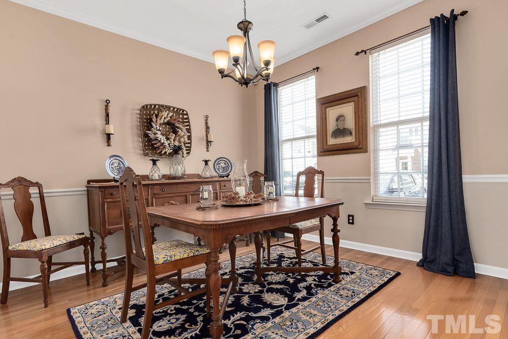 8348 City Loft Court Raleigh, NC 27613 - Photo 4 of 24 a view of a dining room with furniture and chandelier
