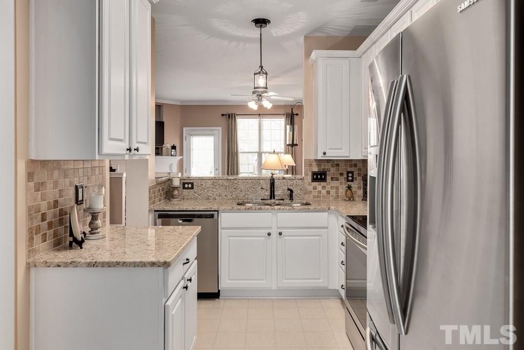 8348 City Loft Court Raleigh, NC 27613 - Photo 6 of 24 a kitchen with stainless steel appliances granite countertop a sink stove and refrigerator