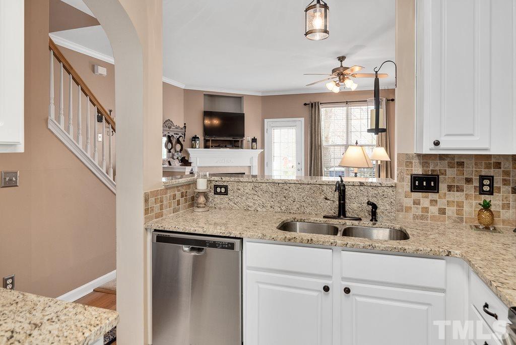 8348 City Loft Court Raleigh, NC 27613 - Photo 9 of 24 a kitchen with stainless steel appliances granite countertop a sink stove and cabinets
