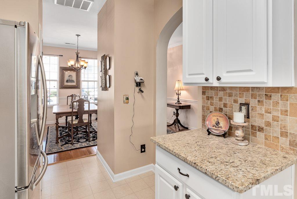 8348 City Loft Court Raleigh, NC 27613 - Photo 10 of 24 a kitchen with stainless steel appliances granite countertop a refrigerator and a sink