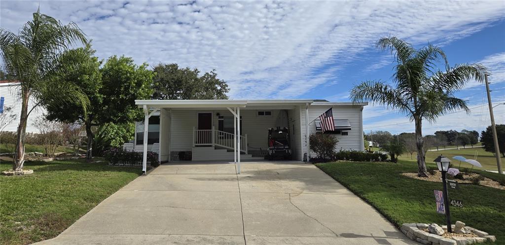 4146 Greenbluff Road, Unit 817 Zellwood, FL 32798 - Photo 1 of 40 front view of a house with a yard and potted plants