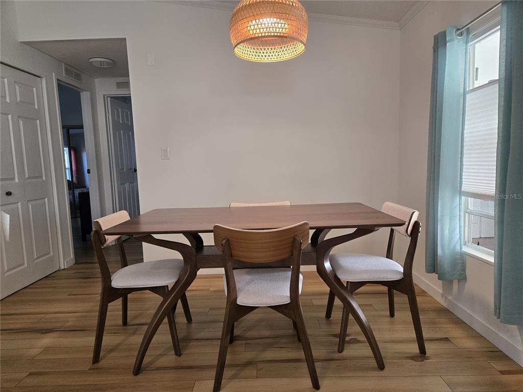4146 Greenbluff Road, Unit 817 Zellwood, FL 32798 - Photo 12 of 40 a view of a dining room with furniture and wooden floor