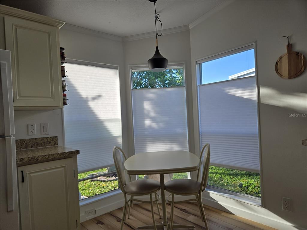 4146 Greenbluff Road, Unit 817 Zellwood, FL 32798 - Photo 17 of 40 a dining room with furniture and a window