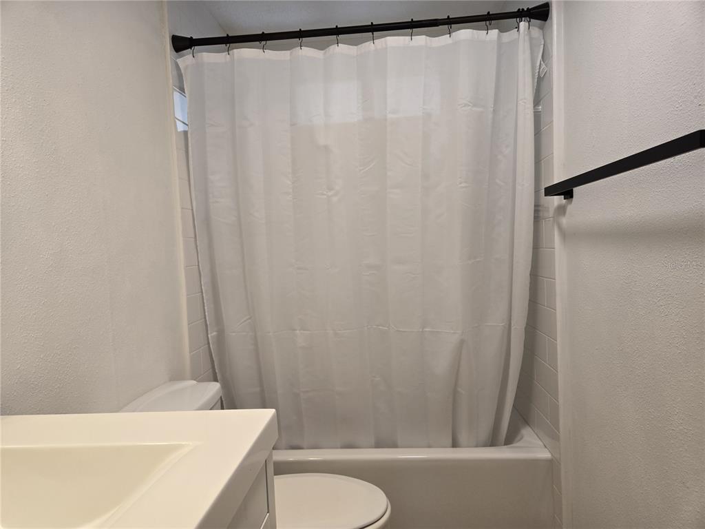 4146 Greenbluff Road, Unit 817 Zellwood, FL 32798 - Photo 20 of 40 a bathroom with a shower curtain and a sink