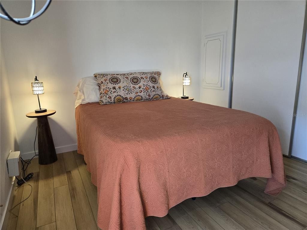 4146 Greenbluff Road, Unit 817 Zellwood, FL 32798 - Photo 22 of 40 a bedroom with a bed and wooden floor