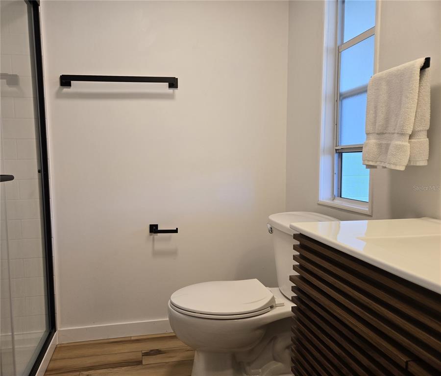 4146 Greenbluff Road, Unit 817 Zellwood, FL 32798 - Photo 25 of 40 a bathroom with a sink a toilet and a window