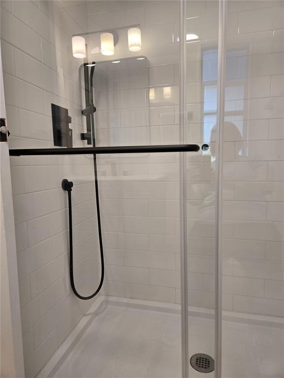 4146 Greenbluff Road, Unit 817 Zellwood, FL 32798 - Photo 26 of 40 a bathroom with a glass shower door