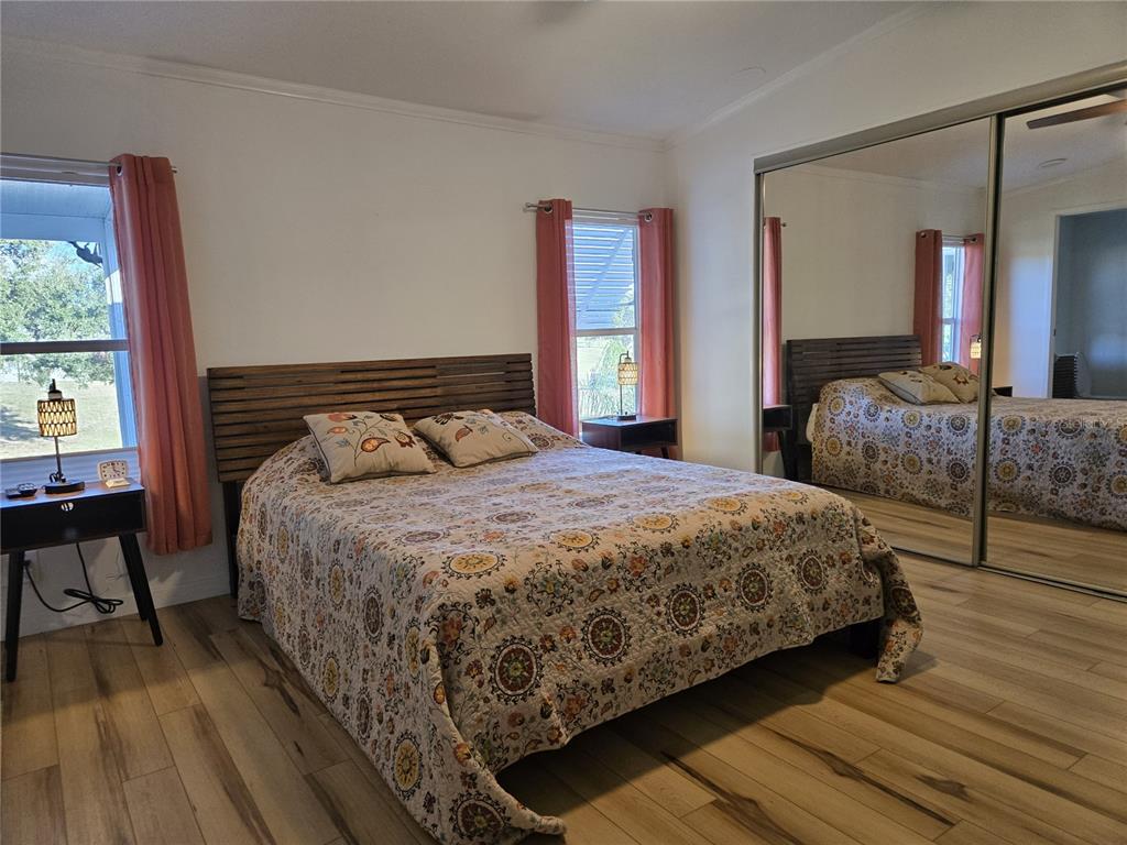 4146 Greenbluff Road, Unit 817 Zellwood, FL 32798 - Photo 27 of 40 a bedroom with a bed and a large window