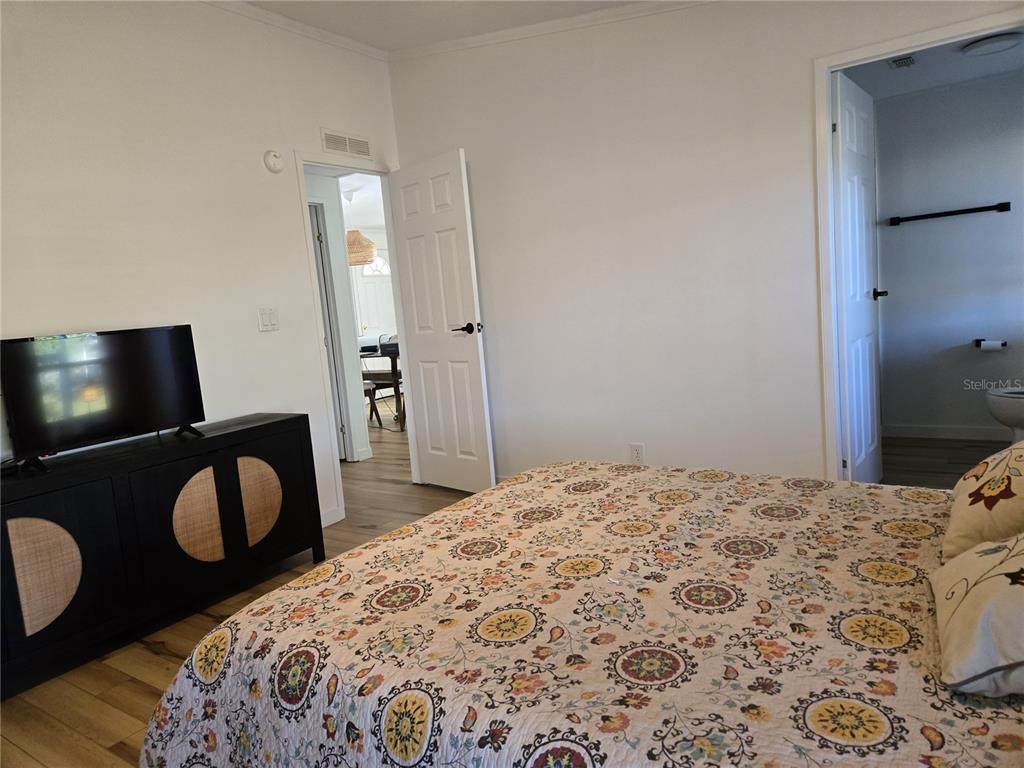 4146 Greenbluff Road, Unit 817 Zellwood, FL 32798 - Photo 28 of 40 a bedroom with a bed and with a mirror