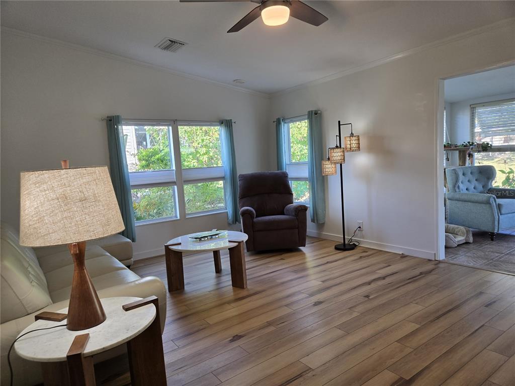 4146 Greenbluff Road, Unit 817 Zellwood, FL 32798 - Photo 31 of 40 a living room with furniture and a window