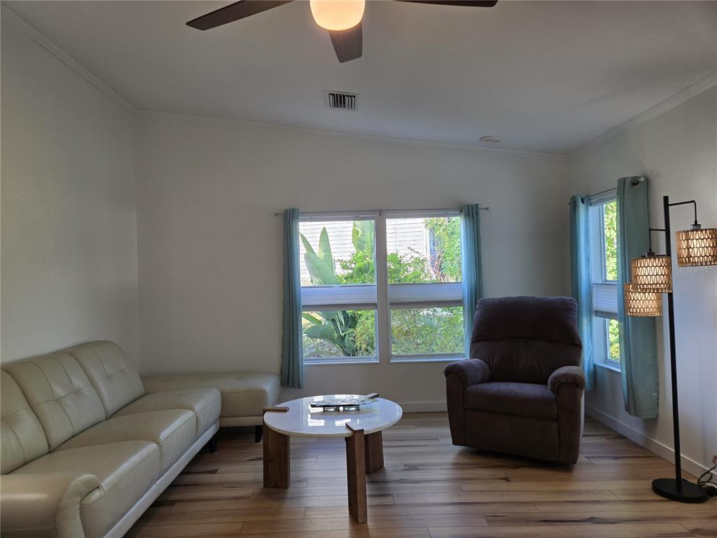 4146 Greenbluff Road, Unit 817 Zellwood, FL 32798 - Photo 33 of 40 a living room with furniture and a window
