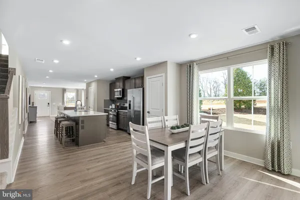 a view of a dining room with furniture window and wooden floor