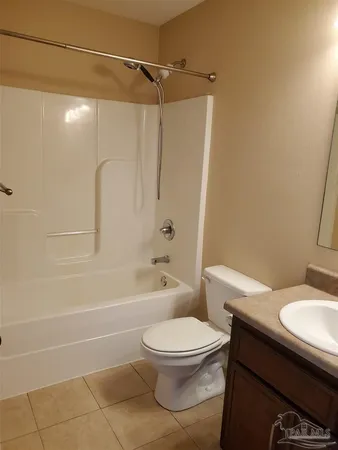 a white toilet sitting next to a bathroom sink and a shower