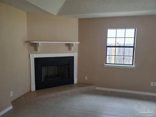 a living room with a fireplace and a window