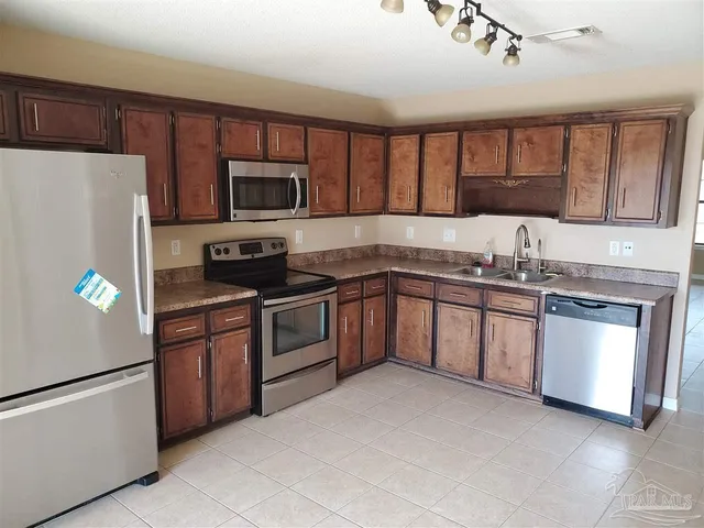 a kitchen with a sink stove and microwave