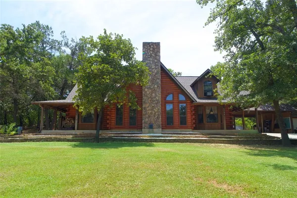 a house view with swimming pool in front of it