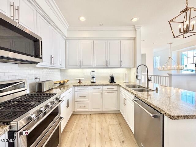 3640 Islander Walk Oxnard, CA 93035 - Photo 11 of 31 a kitchen with stainless steel appliances granite countertop a stove sink and cabinets