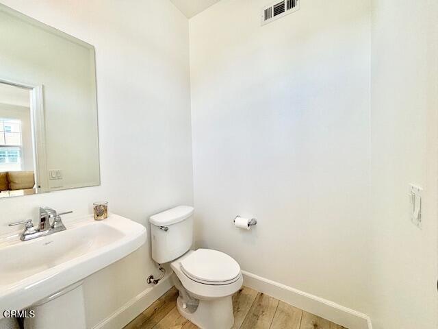 3640 Islander Walk Oxnard, CA 93035 - Photo 16 of 31 a bathroom with a sink a toilet and mirror