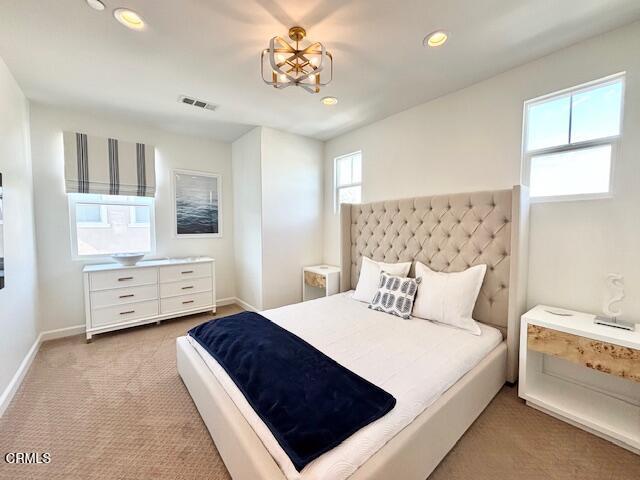 3640 Islander Walk Oxnard, CA 93035 - Photo 17 of 31 a bedroom with a large bed and a chandelier