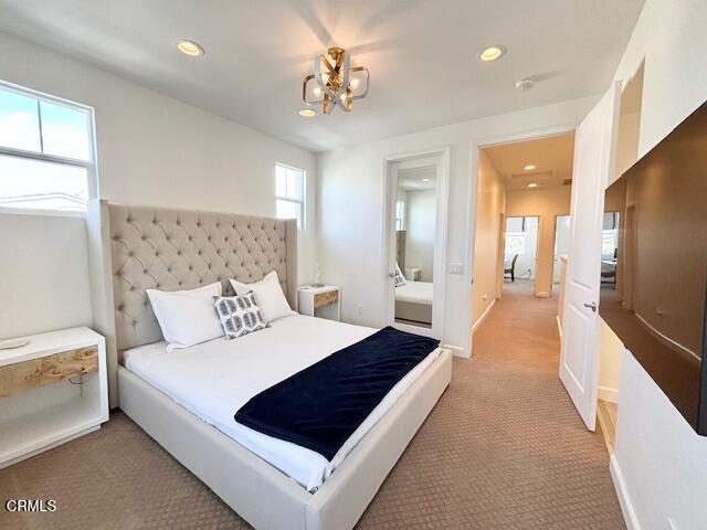 3640 Islander Walk Oxnard, CA 93035 - Photo 18 of 31 a spacious bedroom with a large bed and a chandelier