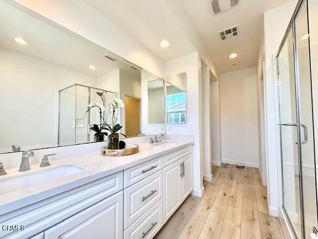 3640 Islander Walk Oxnard, CA 93035 - Photo 20 of 31 a bathroom with a double vanity sink and mirror with shower