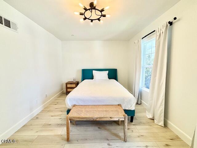 3640 Islander Walk Oxnard, CA 93035 - Photo 28 of 31 a bedroom with a bed and wooden floor