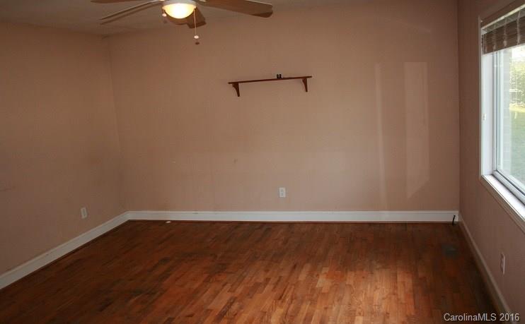 117 Pine Street Rutherfordton, NC 28139 - Photo 2 of 14 a view of a room with wooden floor and fan