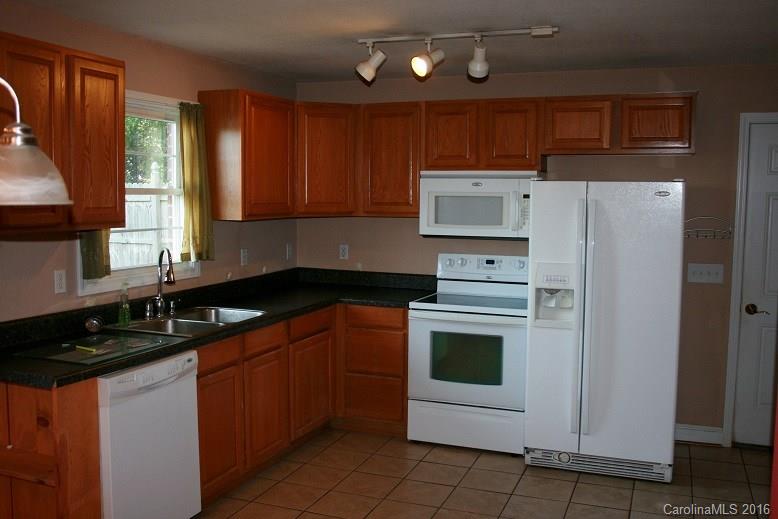 117 Pine Street Rutherfordton, NC 28139 - Photo 3 of 14 a kitchen with stainless steel appliances granite countertop a sink stove and refrigerator