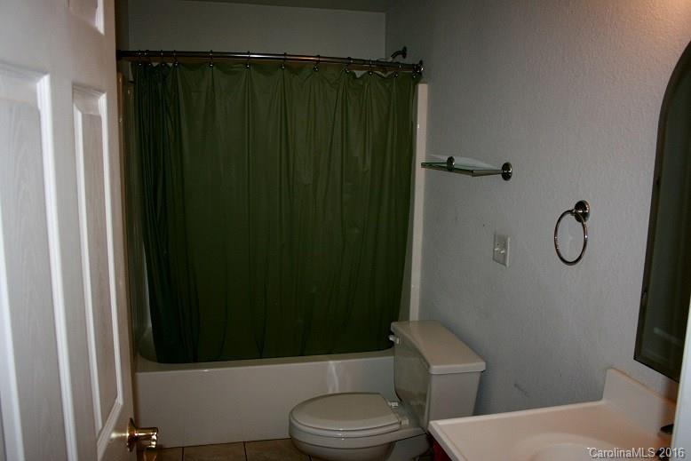 117 Pine Street Rutherfordton, NC 28139 - Photo 7 of 14 a bathroom with a toilet and a shower