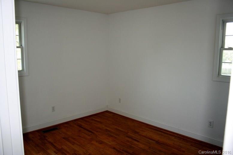 117 Pine Street Rutherfordton, NC 28139 - Photo 8 of 14 a view of an empty room with wooden floor and a window