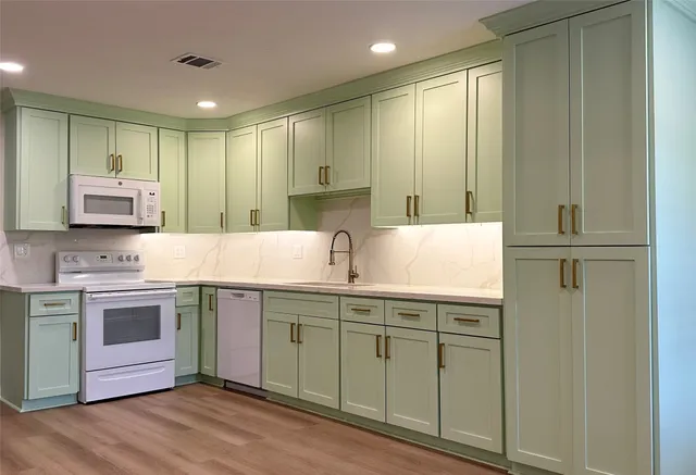 a bathroom with a sink a toilet and vanity