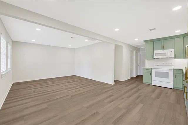 a kitchen with kitchen island granite countertop a sink stainless steel appliances and cabinets