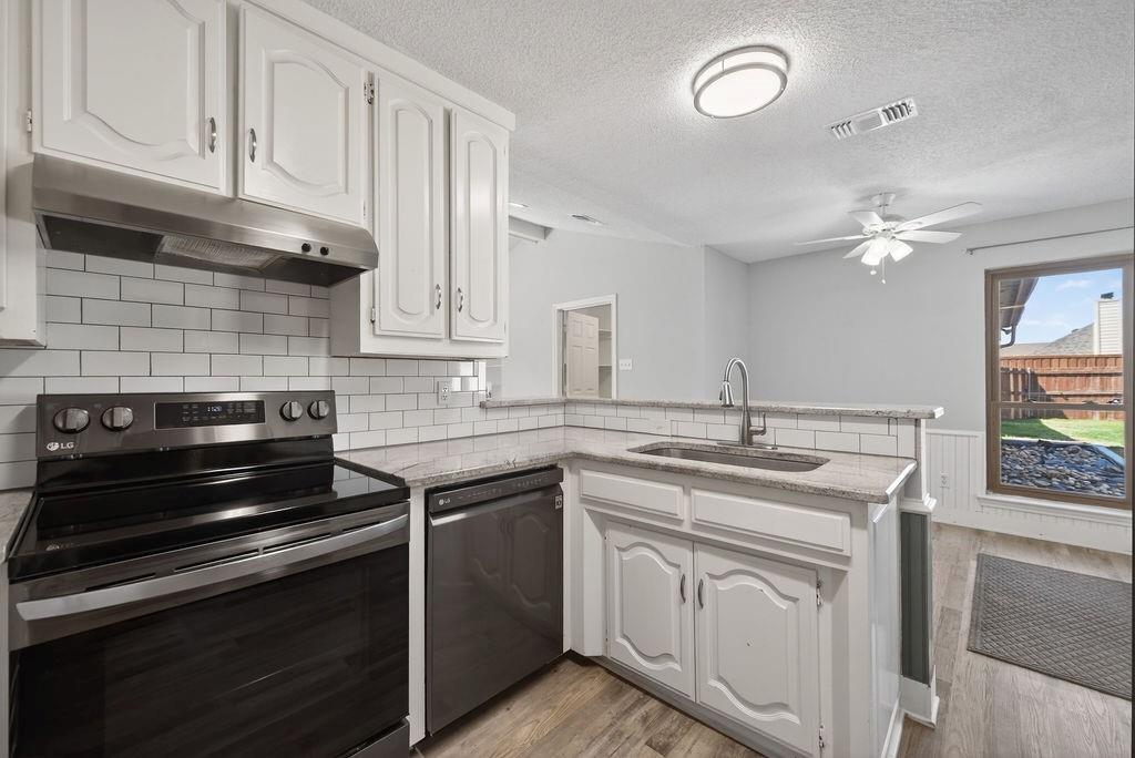 2229 Country Valley Road Garland, TX 75041 - Photo 20 of 34 a kitchen with white cabinets and appliances