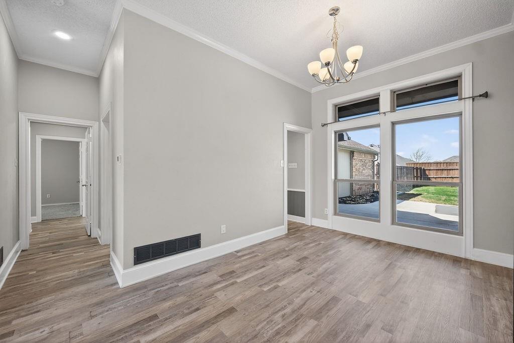 2229 Country Valley Road Garland, TX 75041 - Photo 22 of 34 a view of an empty room with wooden floor and a window