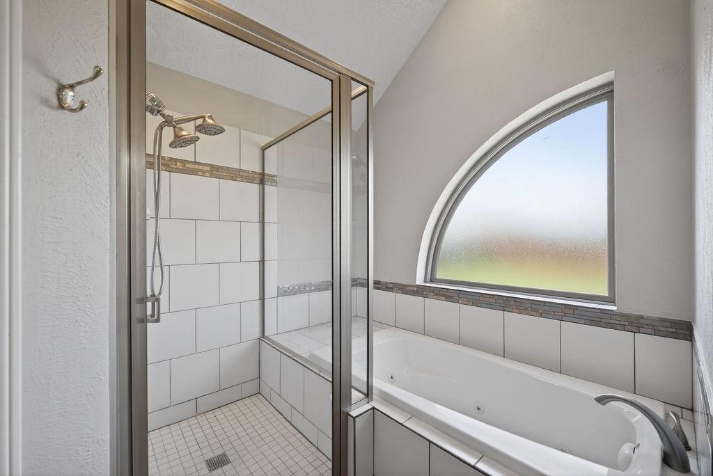 2229 Country Valley Road Garland, TX 75041 - Photo 24 of 34 a bathroom with a bathtub and a shower