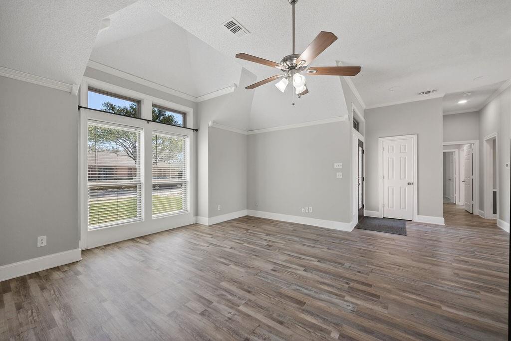 2229 Country Valley Road Garland, TX 75041 - Photo 25 of 34 an empty room with wooden floor fan and windows
