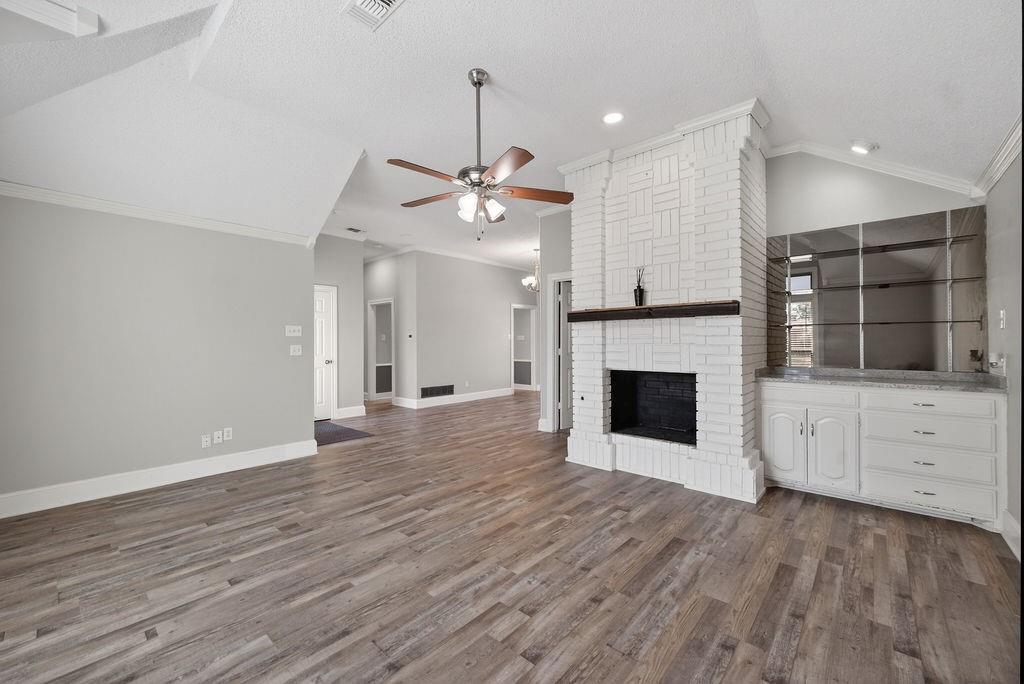 2229 Country Valley Road Garland, TX 75041 - Photo 27 of 34 wooden floor fireplace and windows in an empty room