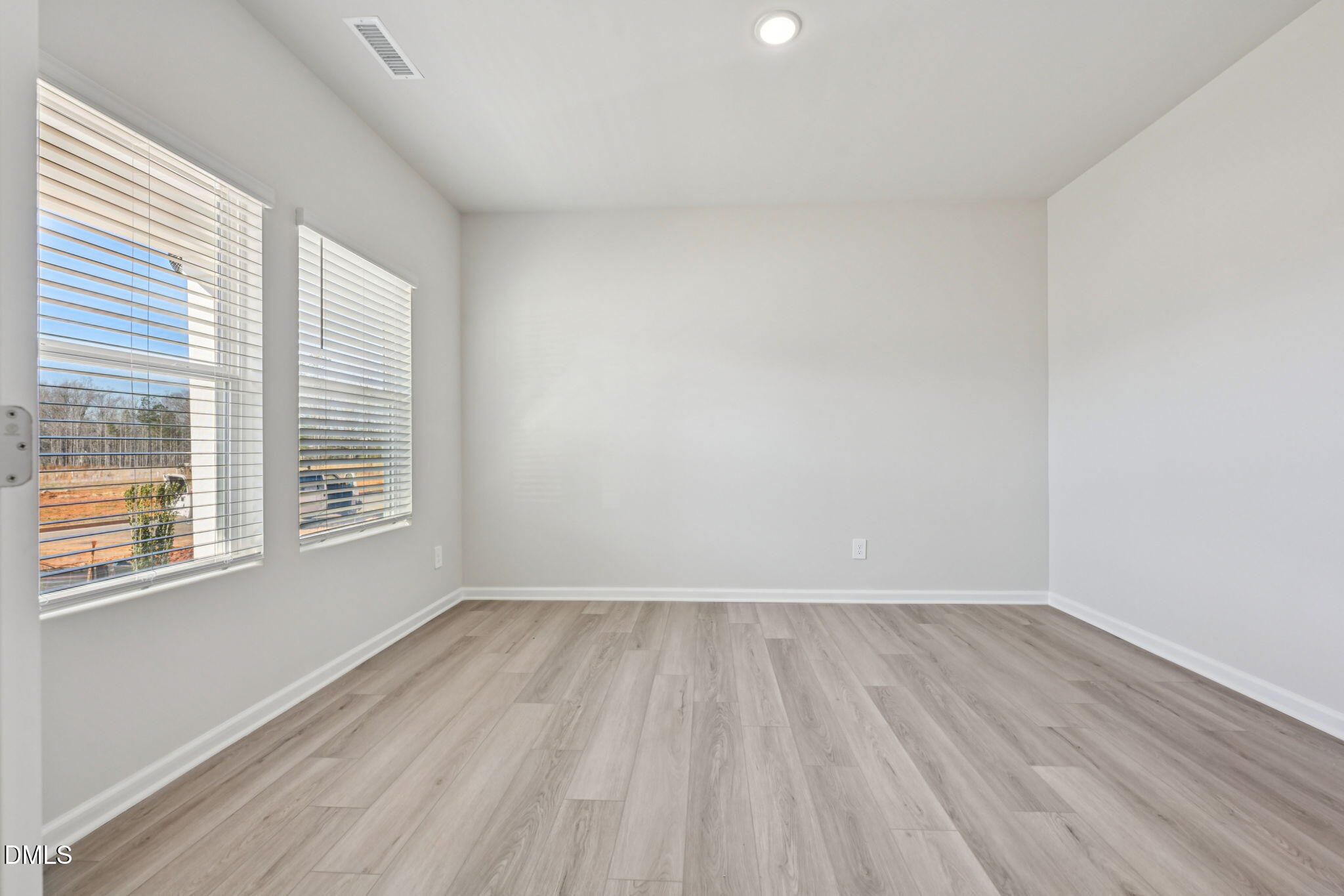 2145 Topsail Road Durham, NC 27703 - Photo 18 of 49 a view of an empty room with wooden floor and a window