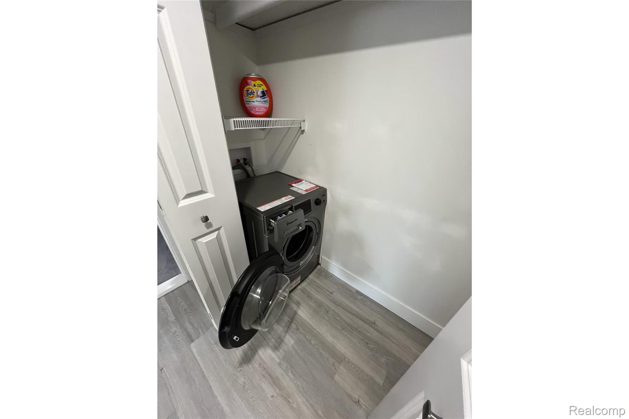2639 Columbia Road, Unit 4 Berkley, MI 48072 - Photo 9 of 9 Laundry closet with wood-finish flooring and a wire storage shelf