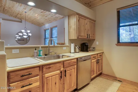 a kitchen with cabinets appliances and a window