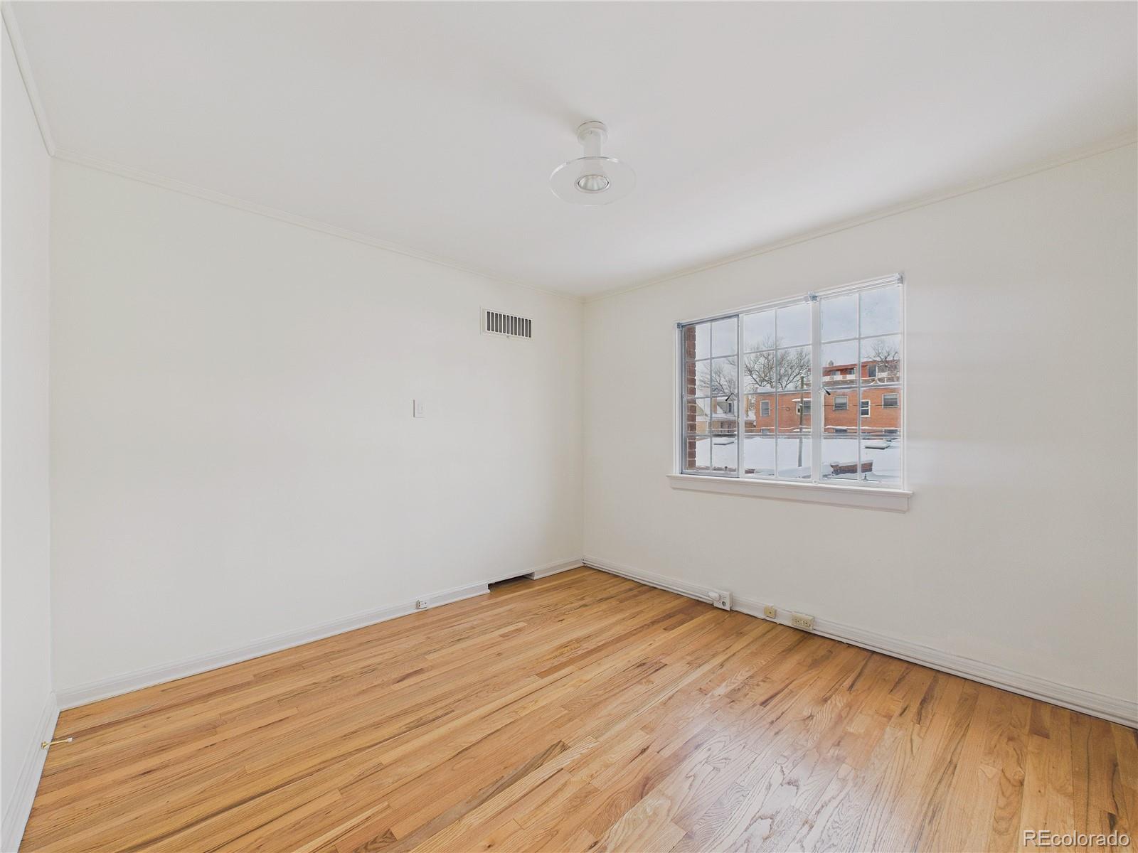 943 Emerson Street, Unit 4 Denver, CO 80218 - Photo 11 of 17 a view of empty room with wooden floor
