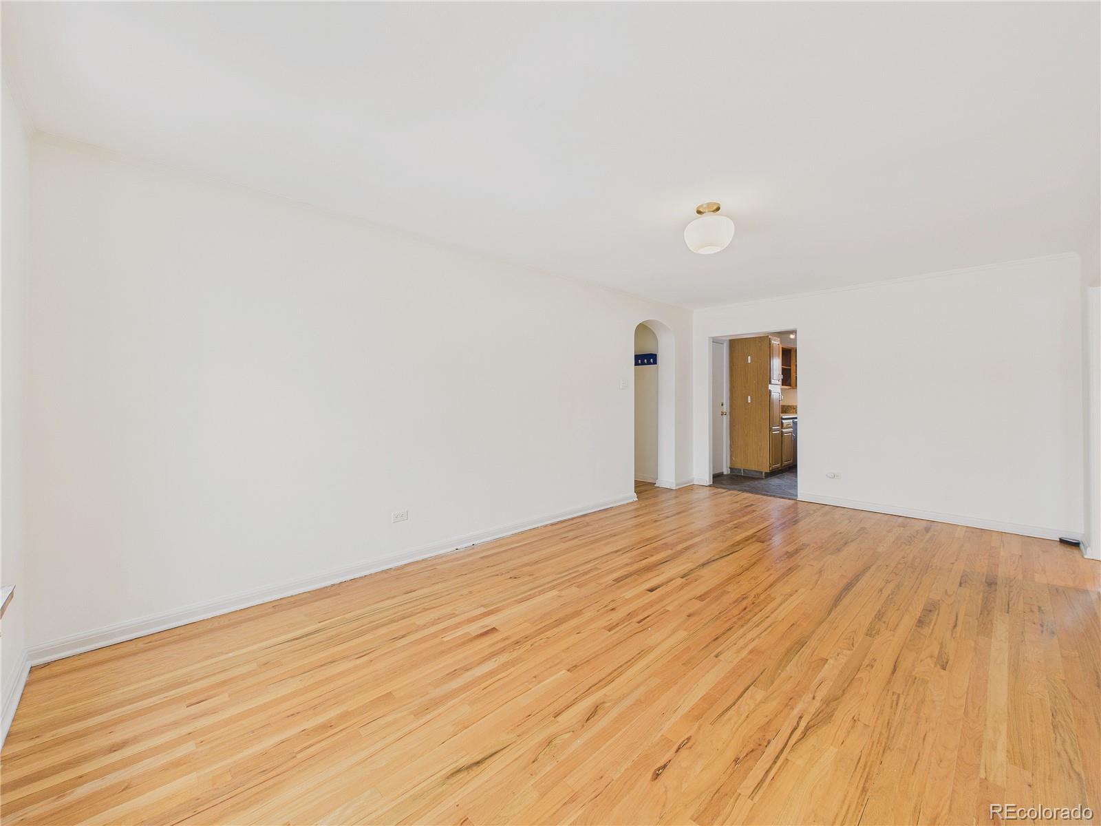 943 Emerson Street, Unit 4 Denver, CO 80218 - Photo 4 of 17 a view of empty room with wooden floor and fan