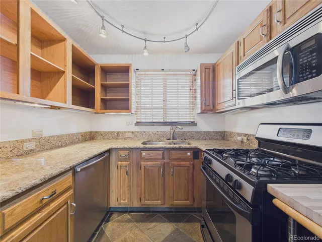 a kitchen with a sink stove and cabinets