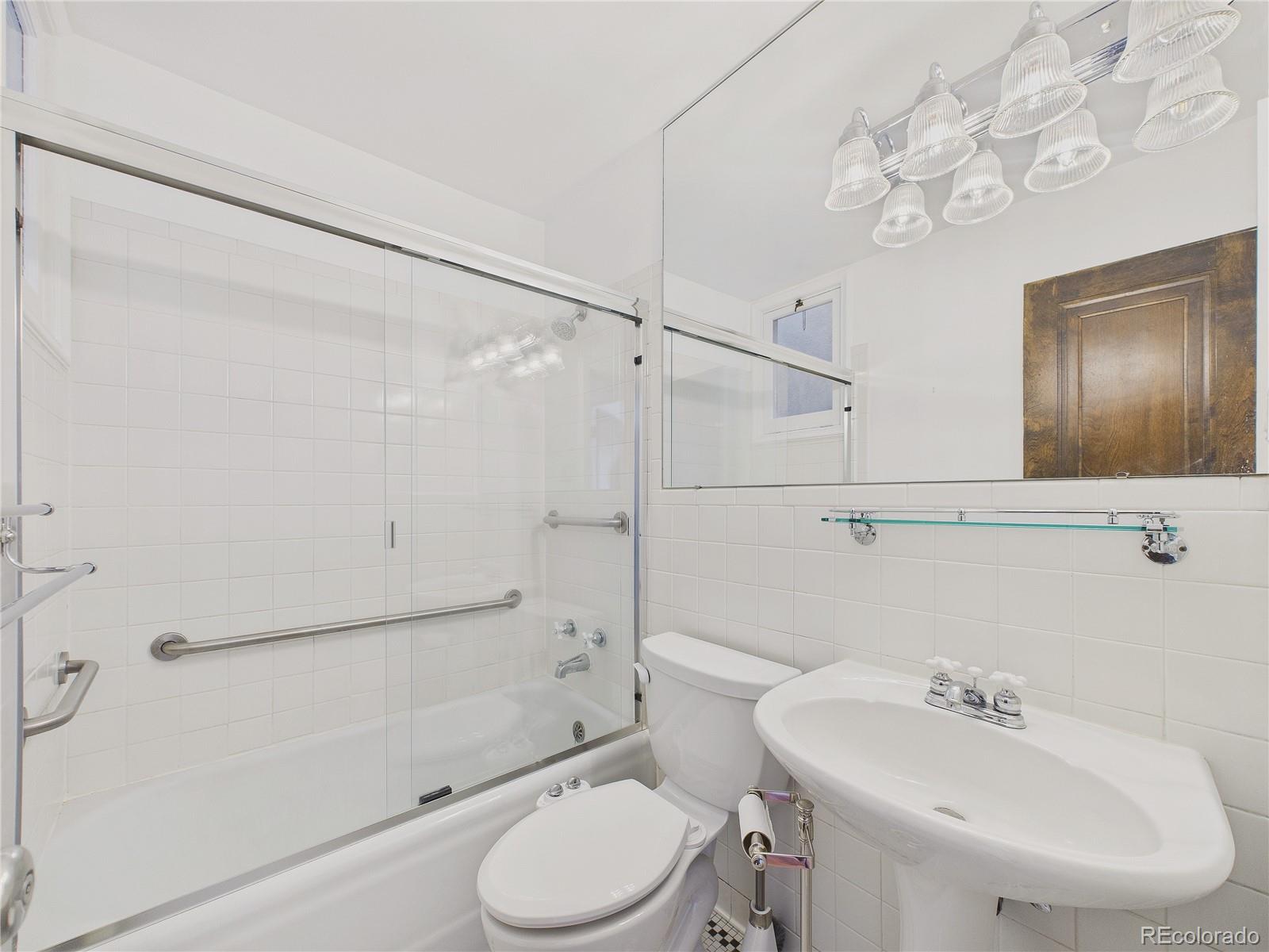 943 Emerson Street, Unit 4 Denver, CO 80218 - Photo 9 of 17 a bathroom with a sink a toilet and shower
