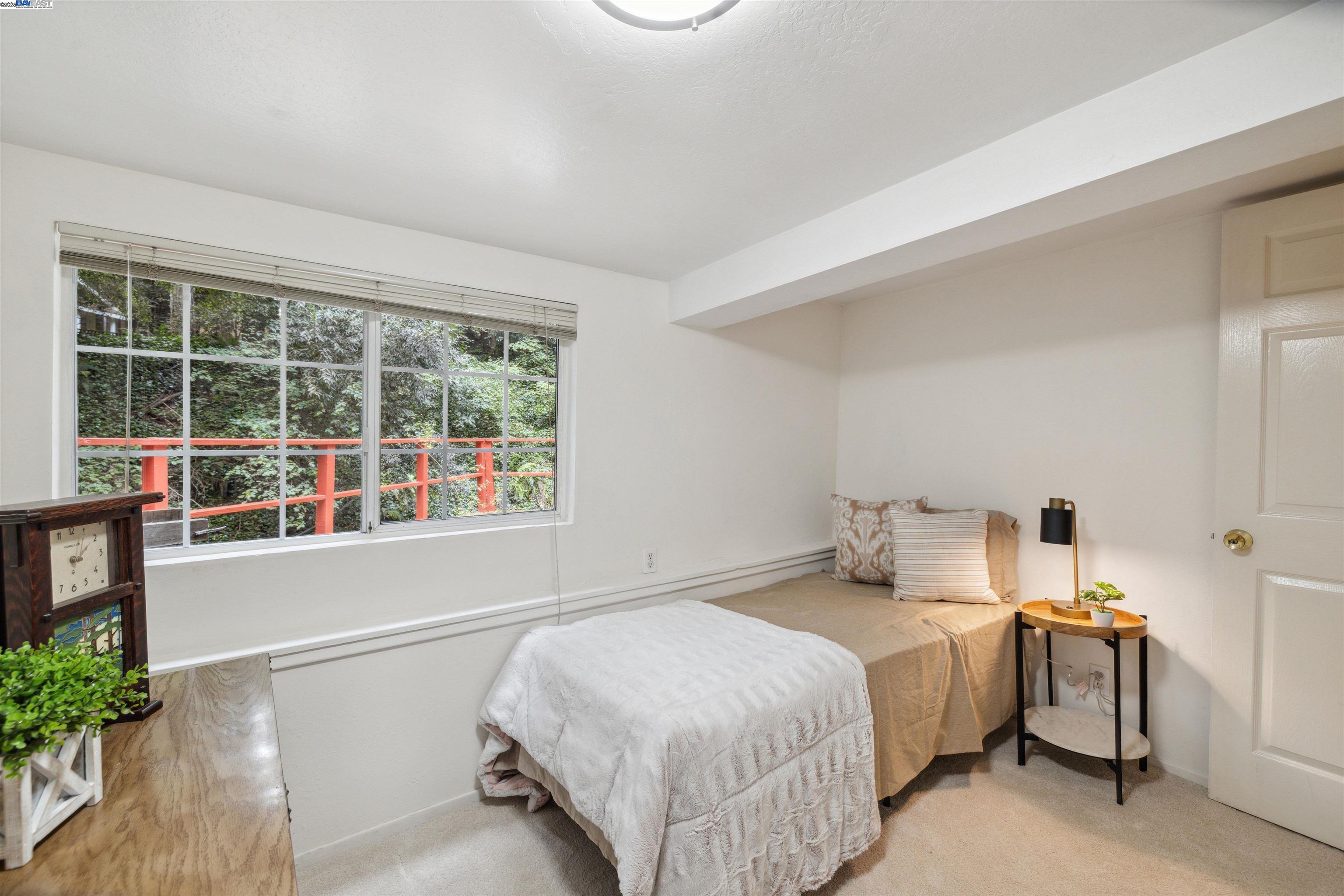 495 Primavera Road Boulder Creek, CA 95006 - Photo 12 of 33 a bedroom with bed and a large window