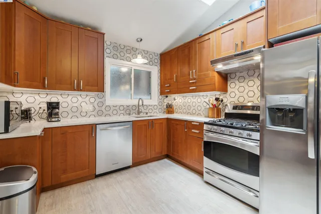 a bathroom with a granite countertop sink a toilet and shower